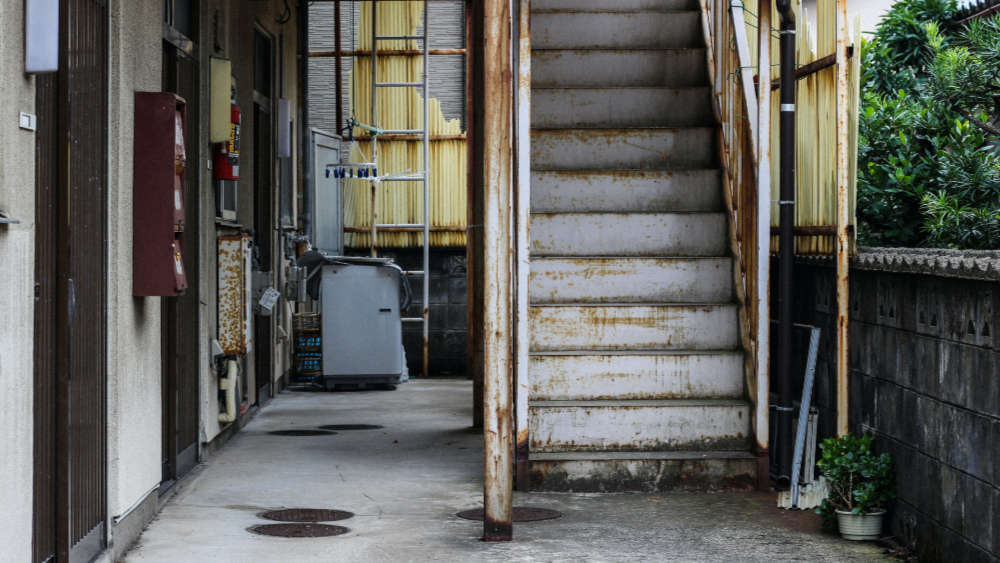 A model of a house with a key beside it symbolizing property maintenance